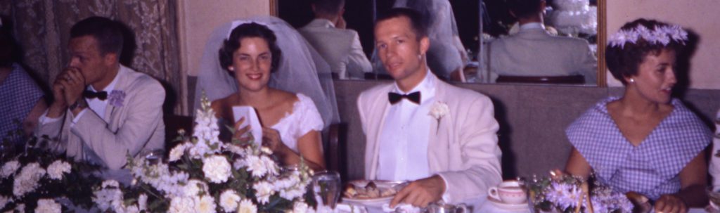 Bride and groom smiling at their wedding reception